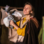 Photo of Bamboozle's PMLD production Makara and the Mountain Dragon. The character Makara looks out at the audience with Volos the baby dragon sitting on her shoulder.