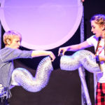 Photo from Bamboozle's AS production Moon Song. Two actors hold silvery tube puppets next to each other.