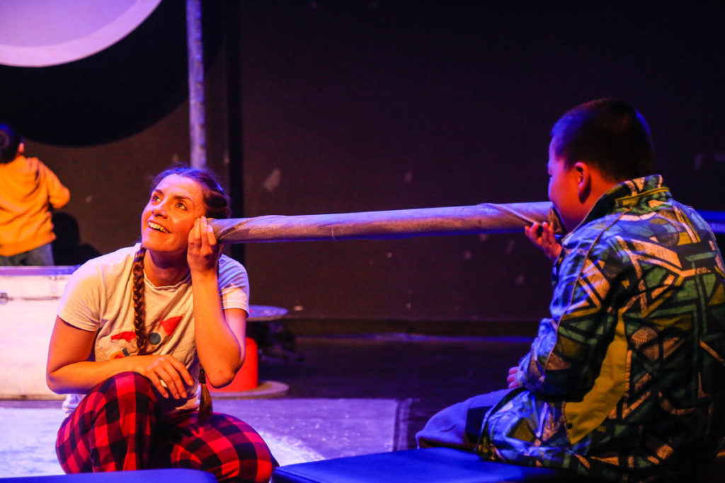 Photos of Bamboozle's AS production Moon Song at Shanghai Children's Art Theatre. An actress listens to the voice on a young audience member through a long silver tube.
