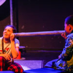 Photos of Bamboozle's AS production Moon Song at Shanghai Children's Art Theatre. An actress listens to the voice on a young audience member through a long silver tube.
