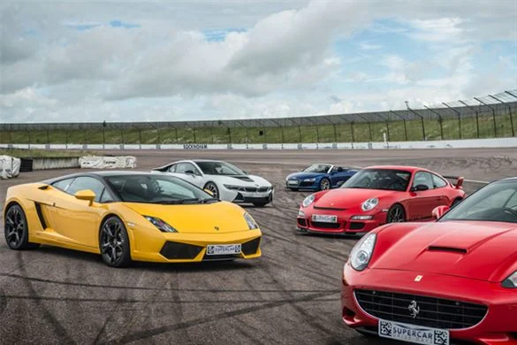 Images showing brightly coloured supercars parked on runway