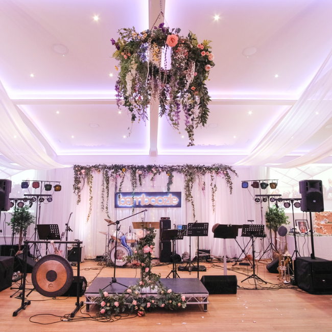 Image of a stage at the bamboozle Gala featuring hanging floral decorations.