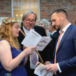 Guests browsing Bamboozle's Gala auction guide and programme