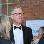 Smartly dressed guests attending Bamboozle fundraising Gala dinner and auction